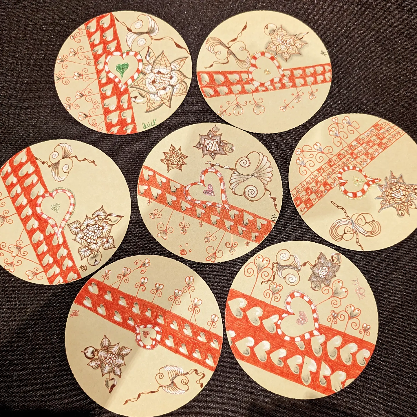 Set of round hand-drawn Zendala tiles with red heart ribbons and delicate floral patterns
