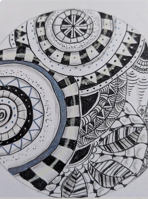 Hand-drawn circular Zentangle study with checkerboard ribbons and botanical patterns